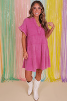 Model wearing a Strawberry Pink Sweetwater Serenade dress with short sleeves and a tiered silhouette.