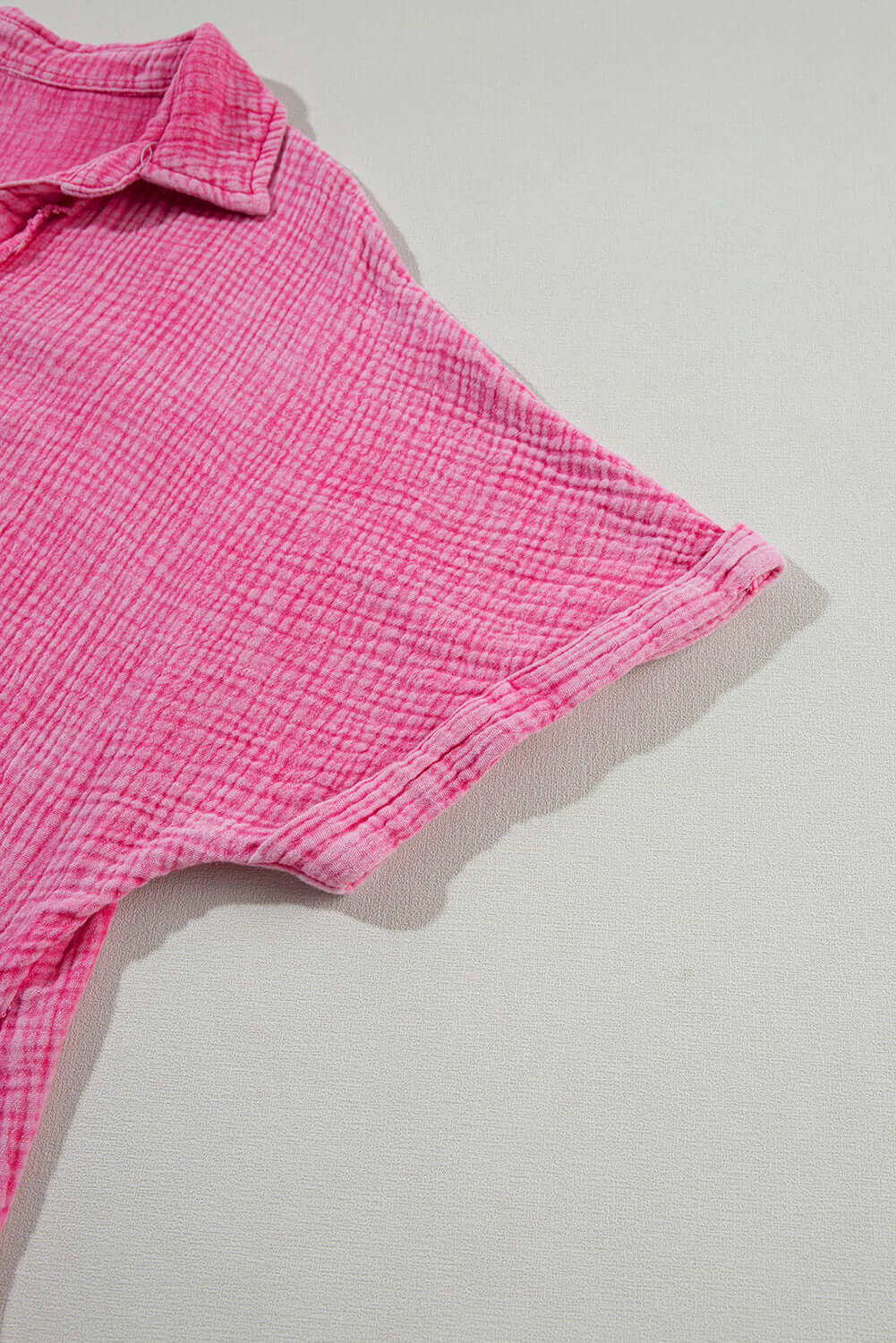 Close-up of the neckline and sleeve of the Sweetwater Serenade pink mineral-wash dress, showcasing its crinkle texture.