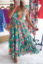 Summer Symphony Dress features a vibrant pink floral print max with tiered ruffles and soft shoulder straps.