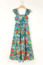 Vibrant Summer Symphony Dress featuring bold floral print and tiered ruffle design, perfect for sunny days. 