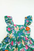 Vibrant green floral dress with ruffled straps and colorful floral pattern for summer occasions.