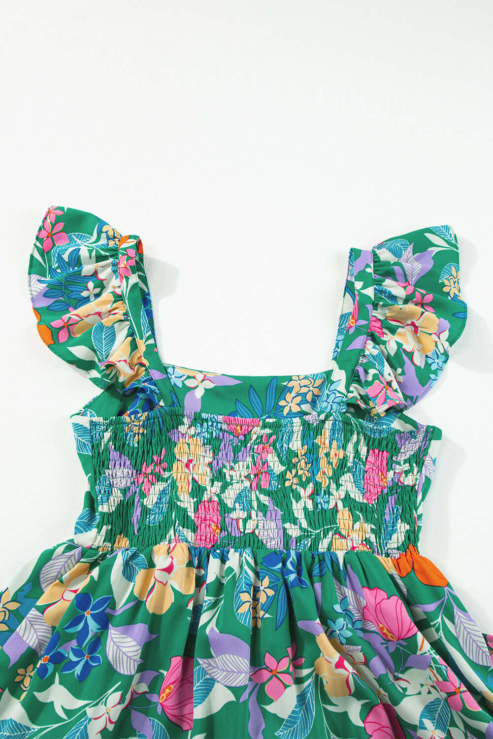 Green floral dress with ruffled sleeves and smocked bodice, perfect for summer outings.