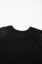 Back view of the Shadow Luxe Dress highlighting lace sleeves and soft pleated neckline in elegant black.