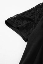 Close-up of the lace sleeve on the Shadow Luxe Dress, showcasing its delicate black lace detailing.