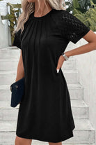 Chic black Shadow Luxe dress with lace sleeves and pleated neckline for a stylish look.