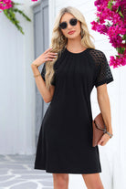 Chic black Shadow Luxe Dress with lace sleeves and pleated neckline, perfect for casual or dressy occasions.