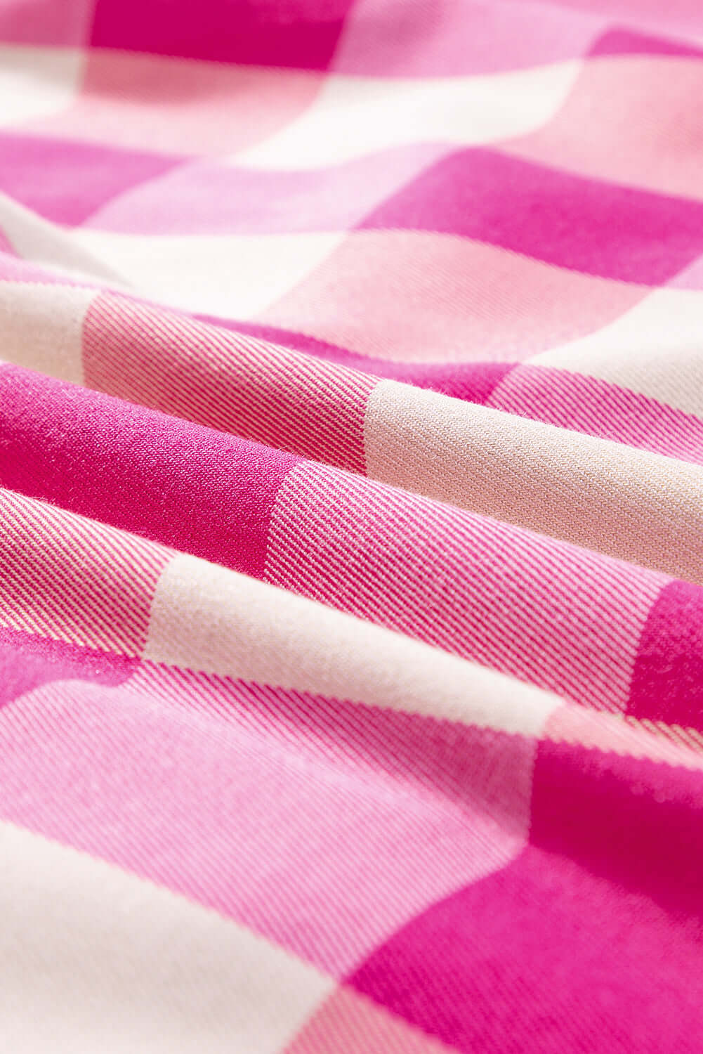 Close-up of soft pink and white checkered fabric, ideal for the stylish Check Her Out Dress.