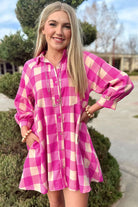 Model wearing a trendy pink and cream checkered dress with collared neck and bracelet sleeves.