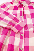 Close-up of the Check Her Out Dress featuring a pink plaid pattern, collared neck, and bracelet sleeves.