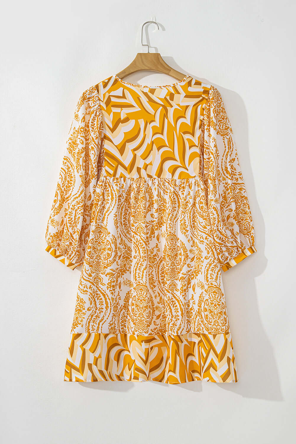 Golden Maize Dress with bohemian print, puff sleeves, and tied V-neckline on hanger, showcasing fit-and-flare silhouette by Vivian-Lu.