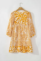 Golden Maize Dress with bohemian print, puff sleeves, and tied V-neckline on hanger, showcasing fit-and-flare silhouette by Vivian-Lu.