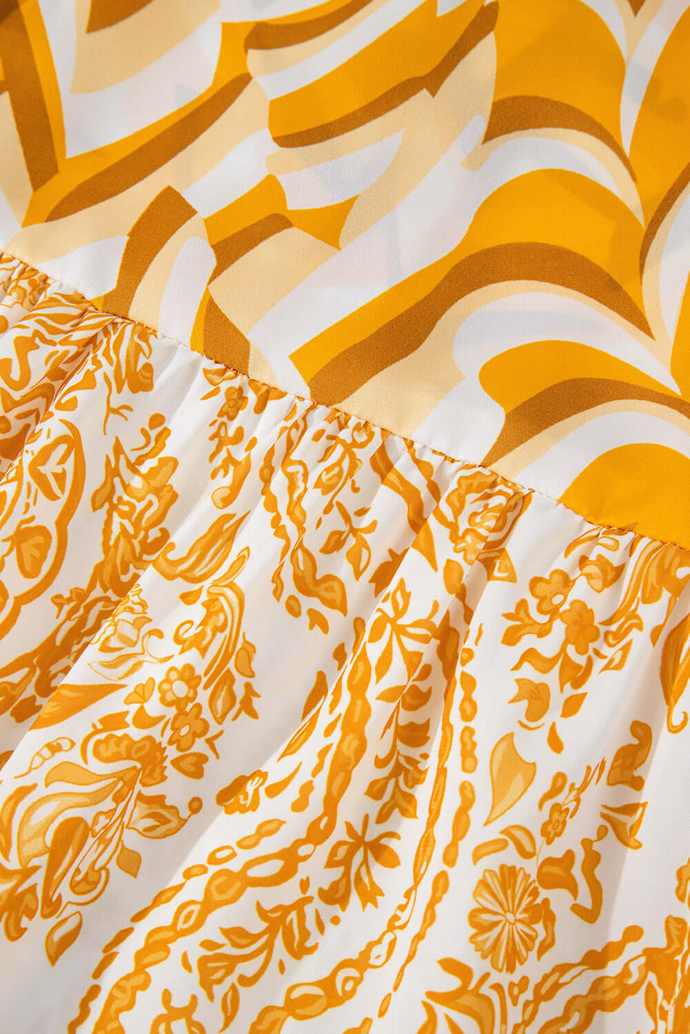 Close-up of Golden Maize dress fabric with chic bohemian print in shades of yellow and white, showcasing intricate patterns.