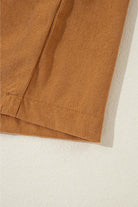 Close-up of copper corduroy fabric showcasing luxurious texture of DESERT WINDS Dress with pleating and puff sleeves.