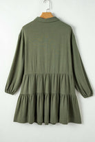 Jungle Green VENTURE OUT Dress with puff sleeves and tiered pleated design, back view on hanger.