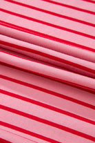 Close-up of soft pink fabric featuring red stripes, perfect for the stylish Strawberry Sundays Dress.