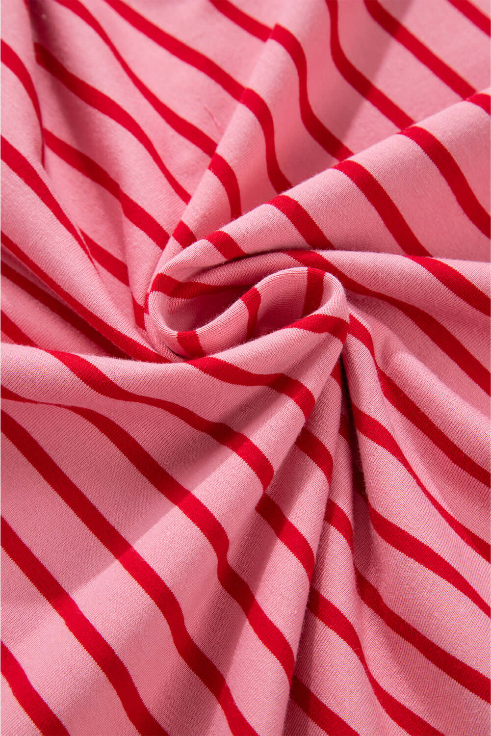 Close-up of pink and red striped fabric showcasing the soft, comfortable material of the Strawberry Sundays Dress.