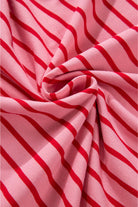 Close-up of pink and red striped fabric showcasing the soft, comfortable material of the Strawberry Sundays Dress.