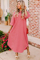 Model wearing the STRAWBERRY SUNDAYS DRESS, a striped, comfortable dress with a crew neck and drop shoulders.