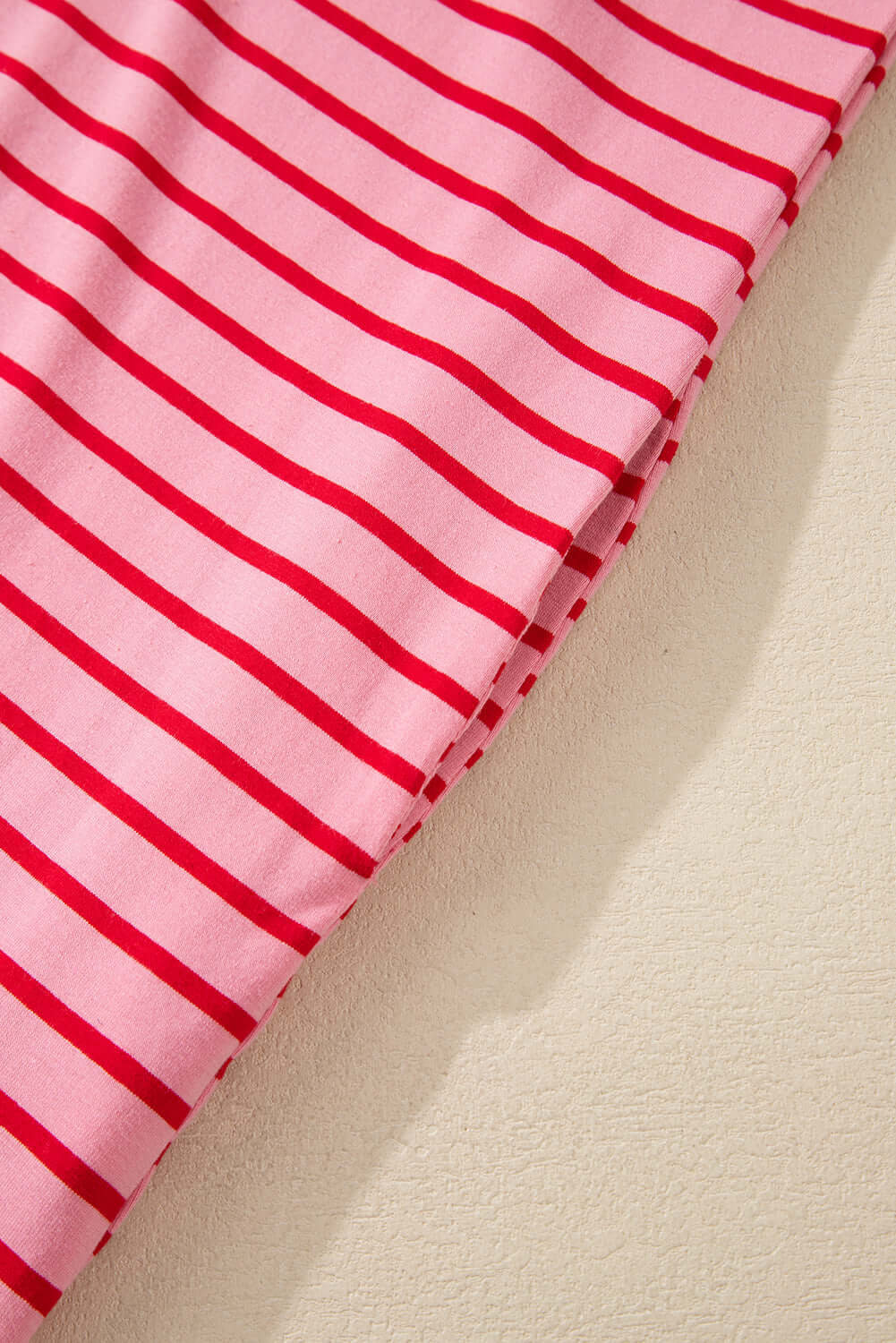 Close-up of fabric featuring pink and red stripes suitable for the Strawberry Sundays Dress.