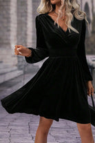 Elegant black velvet midi dress with surplice neckline and high waist.