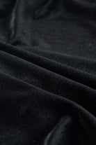 Luxurious black velvet fabric texture of the SABLE SIREN Dress, highlighting its silky smooth drape and premium quality.