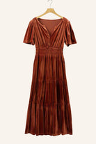 Copper velvet maxi dress with tiered design, short sleeves, and shirred high waist by Vivian-Lu, hanging on a wooden hanger.