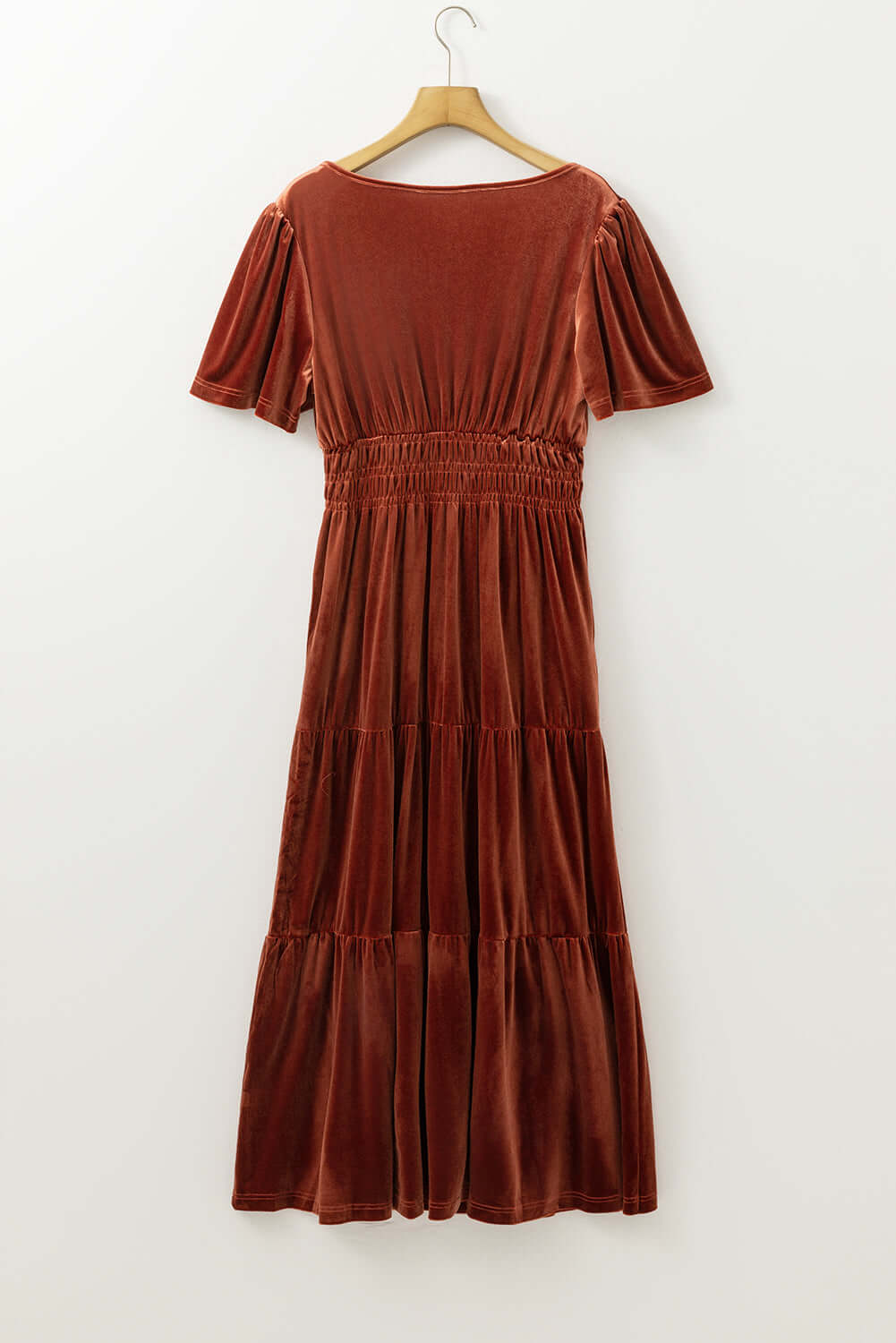 Copper velvet maxi dress by Vivian-Lu featuring tiered design and shirred waist on hanger.