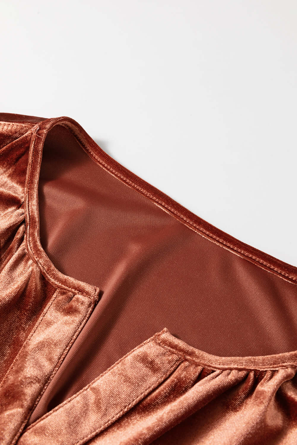 Close-up of copper velvet fabric on PENNY FOR YOUR THOUGHTS Maxi Dress from Vivian-Lu, showcasing its soft, luxurious texture.