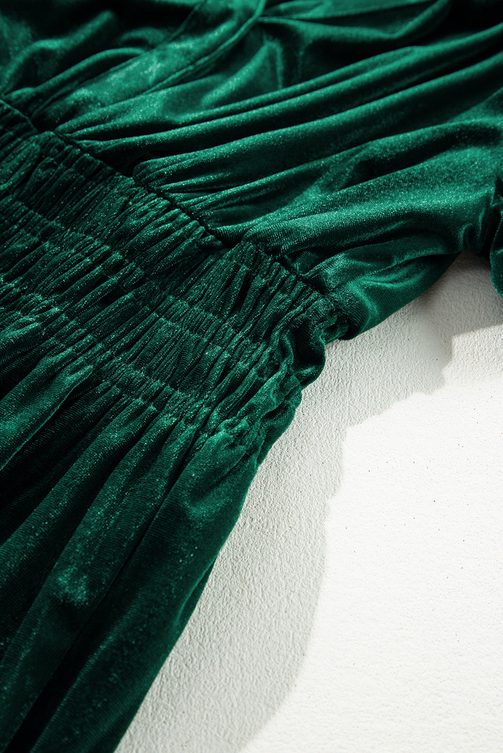 Elegant Emerald velvet maxi dress with tiered design and ruching, showcasing chic short sleeves and boho-inspired style.