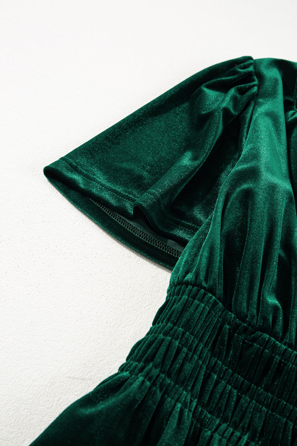 Elegant Emerald Maxi dress with chic short sleeves and tiered design showcasing luxurious green velvet fabric.