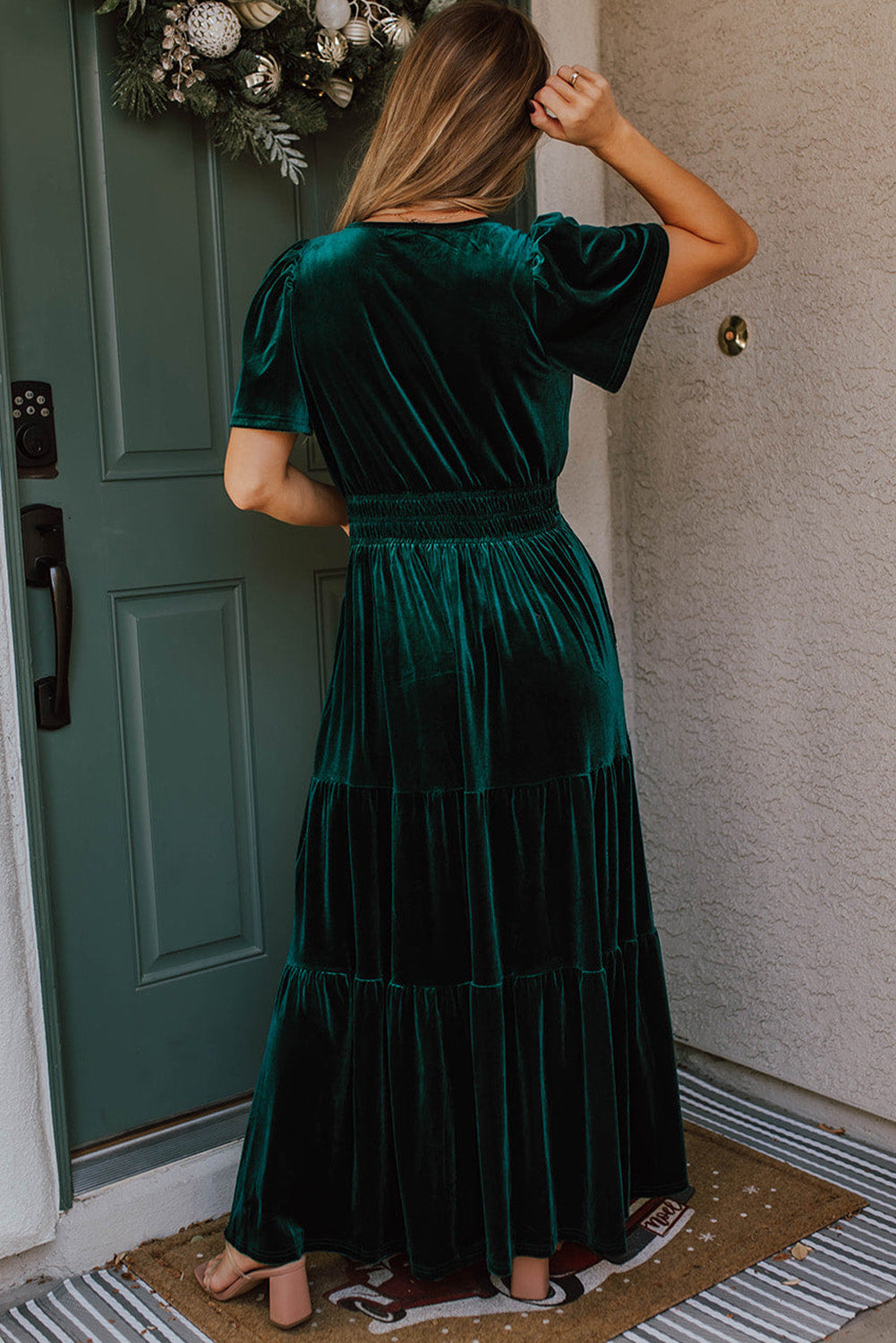 Elegant Emerald velvet maxi dress with chic short sleeves and tiered design, perfect for a stylish boho-inspired look.