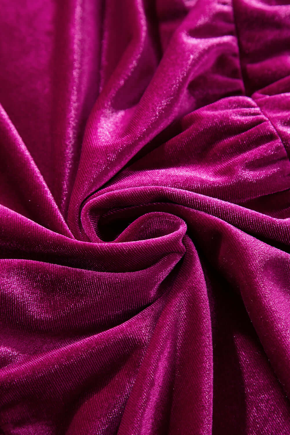 Rich magenta velvet fabric texture with elegant folds and luxurious sheen.