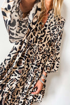 Leopard print dress with button front and tiered ruffles, showcasing a playful and feminine style for a standout look.