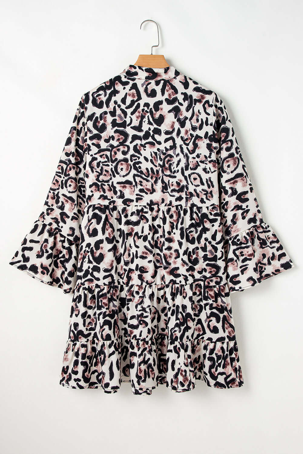 Leopard print dress with tiered ruffles and button front, exuding a playful and feminine vibe.