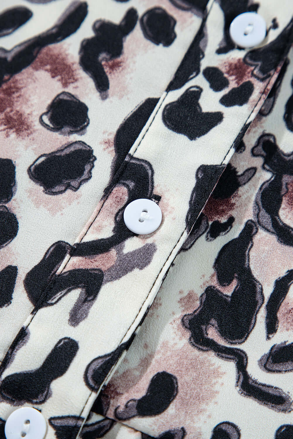 Close-up of leopard print fabric with white buttons on the Walk on The Wild Side Dress.