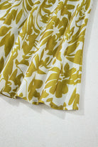 Close-up of floral print fabric from the Spring Time Maxi Dress in green and white, showcasing its elegant design.