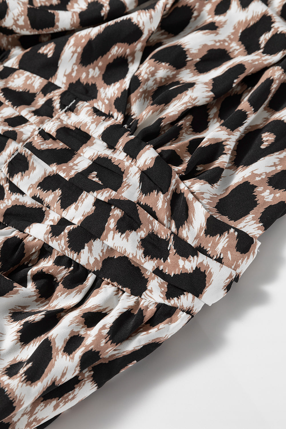 Leopard print fabric detail of the Untamed Beauty maxi dress, showcasing texture and design elements.