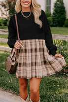 Woman wearing PLAID CHARM Mini Dress by Vivian-Lu with black top and plaid skirt, perfect for stylish casual outings.