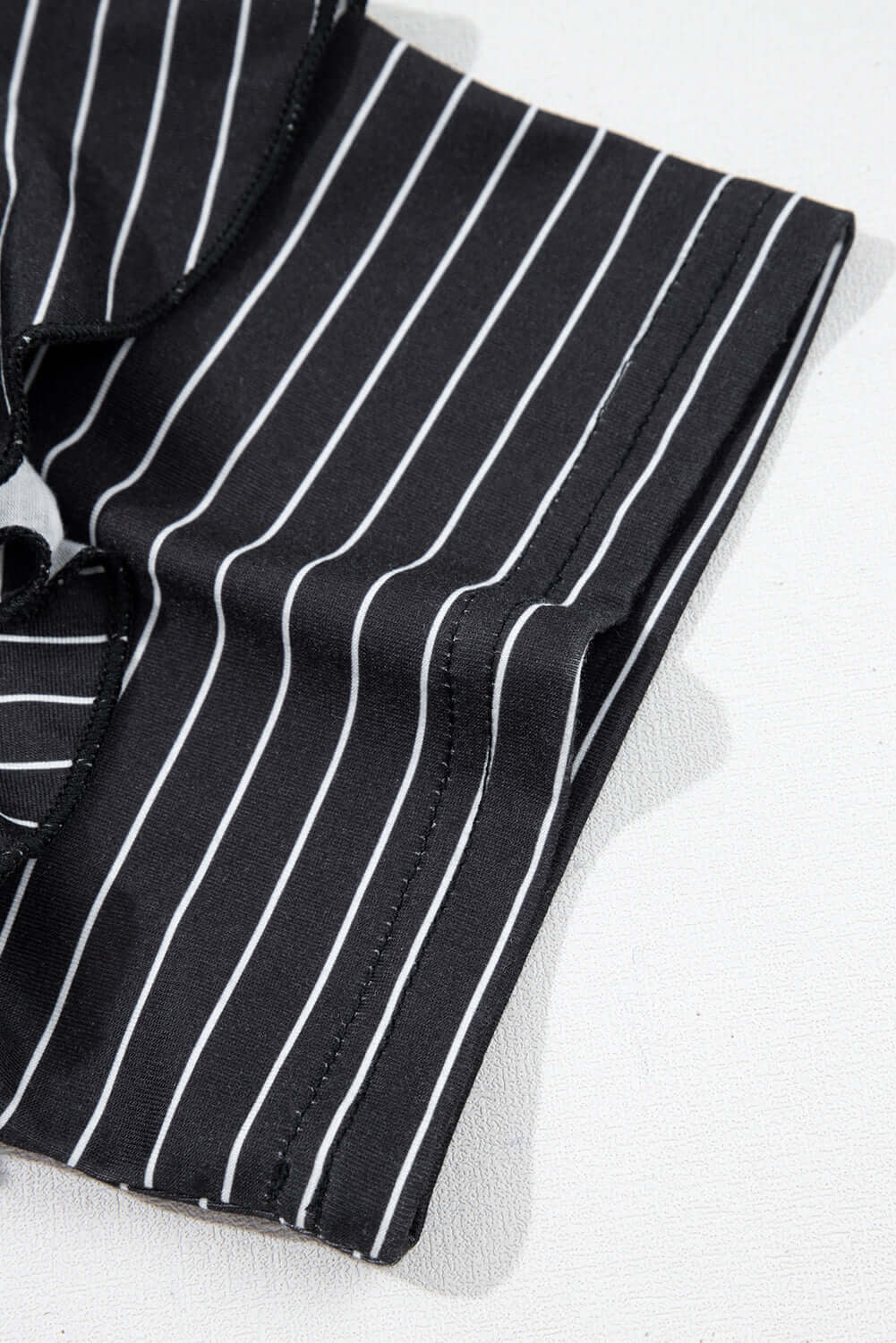 Black and white striped fabric detail of the Perfect Pathways Dress with ruffle sleeves.