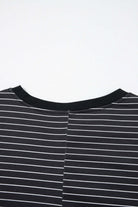 Close-up of the back neckline of the Perfect Pathways black and white striped mini dress with ruffle sleeves.