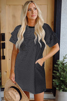 Black striped mini t-shirt dress with ruffle sleeves and pockets, styled casually with a hat.
