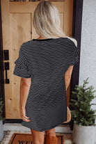 Back view of the Perfect Pathways black striped mini dress with ruffle sleeves and pockets, styled casually.