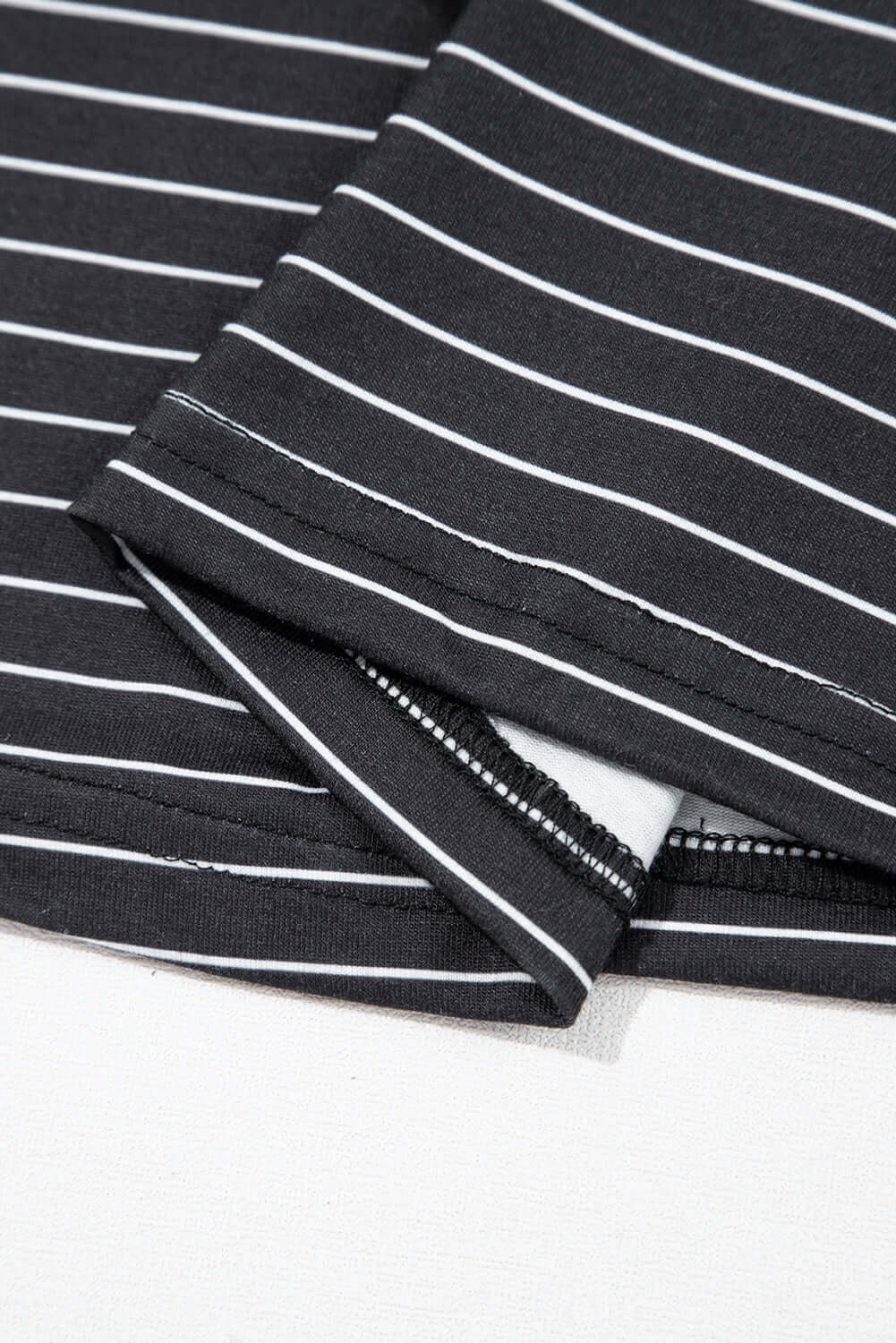 Close-up of black and white striped fabric showing ruffle sleeve detail of Perfect Pathways Dress.