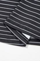 Close-up of black and white striped fabric showing ruffle sleeve detail of Perfect Pathways Dress.