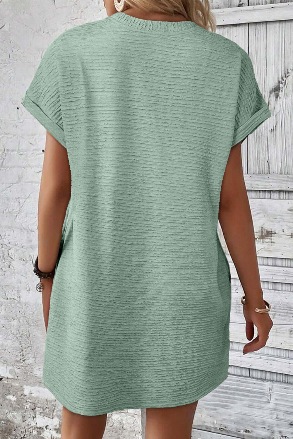Back view of the Minted Moments Dress in soft sage green with crinkle-textured fabric and short sleeves.