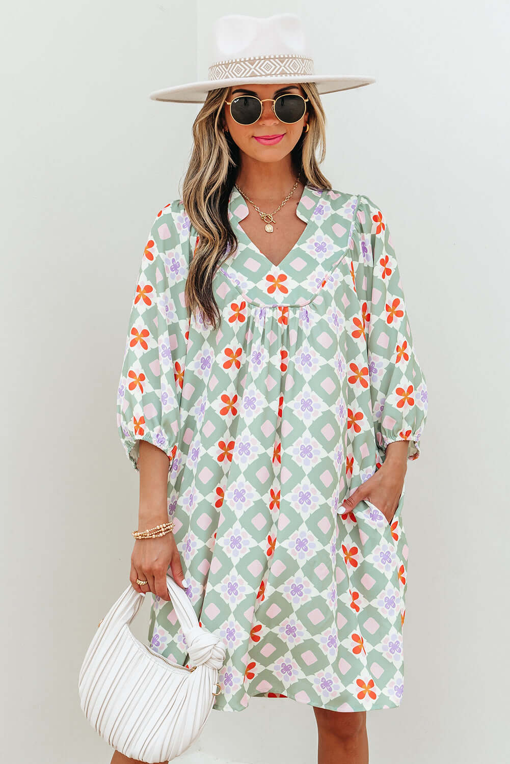 Mint Mosaic Dress featuring a green floral pattern, loose fit, 3/4 puff sleeves, and notched V-neck, perfect for casual outings.
