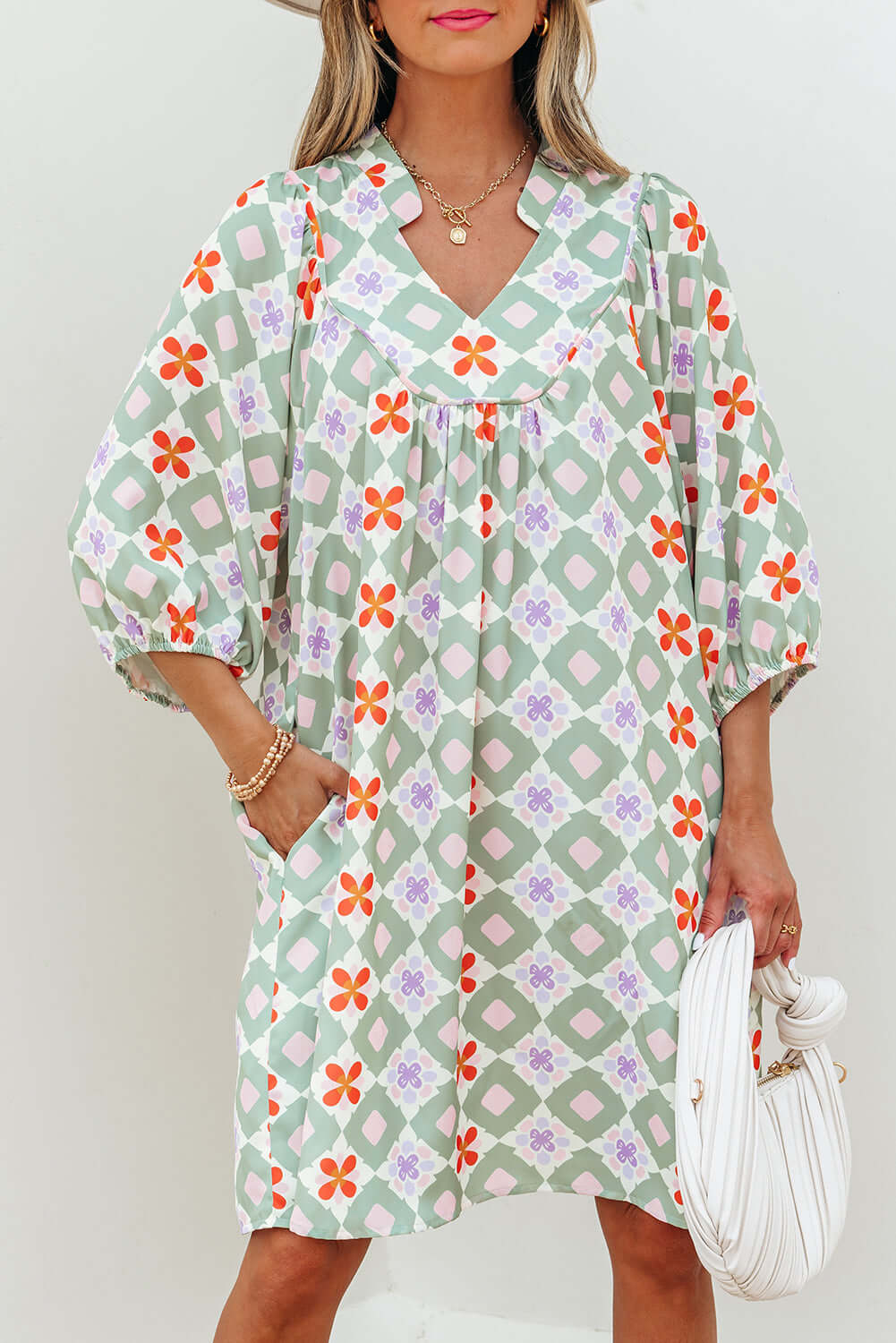 Mint Mosaic Dress featuring a green geometric floral pattern, loose fit, and notched V-neck with 3/4 puff sleeves.