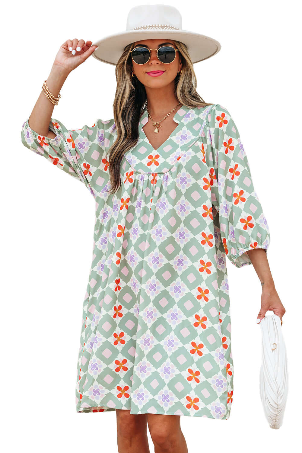 Model wearing a mint mosaic dress featuring a green geometric floral pattern and 3/4 puff sleeves.