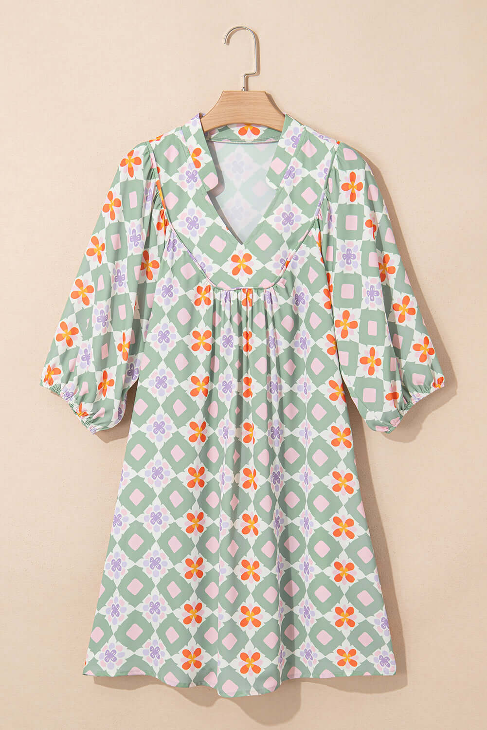 Mint Mosaic Dress featuring a green floral geometric pattern, knee-length silhouette, and 3/4 puff sleeves.
