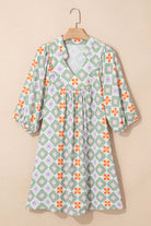 Mint Mosaic Dress featuring a green floral geometric pattern, knee-length silhouette, and 3/4 puff sleeves.